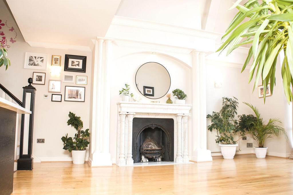 Penthouse photography studio in Dublin with natural light, marble fireplace and gallery wall.