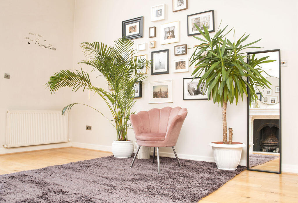 Penthouse photography studio in Dublin with natural light, marble fireplace and gallery wall.